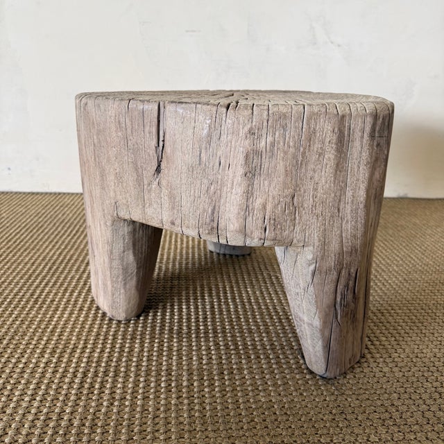 Dimensions: 19" W x 16" D x 13" H Crafted from solid elm wood, this hand-carved stump table brings organic warmth and...
