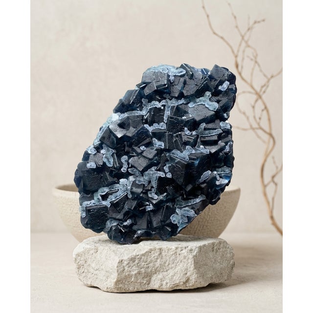 A monumental natural dark blue Fluorite specimen selected for its architectural cubic crystal structure, frosted secondary...