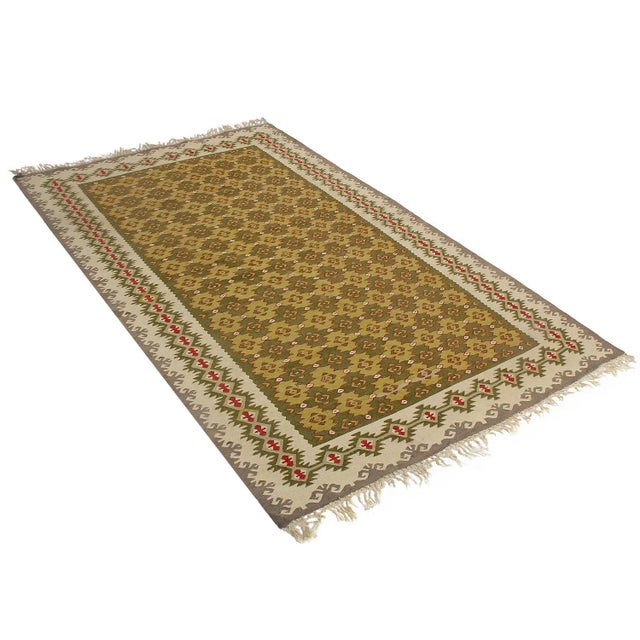 Hand woven in Turkey originating between 1950-1960, this Vintage mid-century wool kilim hails from the seaside town of...