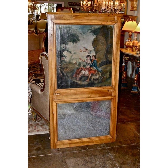 French walnut trumeau frame with oil painting of a romantic couple and cherub in a meadow with trees and flowers...