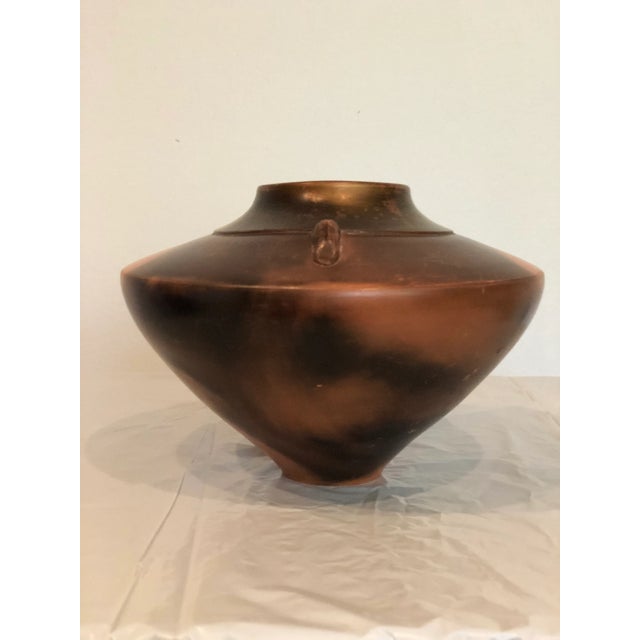 The shape and glaze on this artist signed pottery is wonderful. Delicately applied handles with a beautiful brown, black...