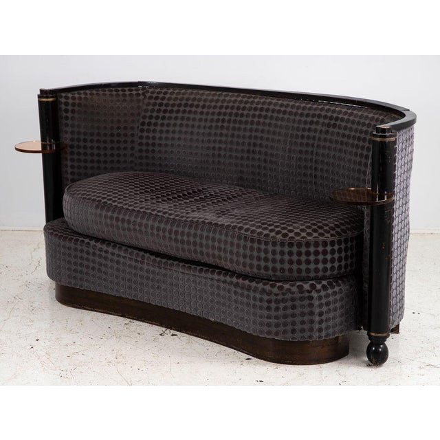 This striking French Art Deco velvet sofa is a rare and visionary piece featuring a kidney-shaped design on a platform...