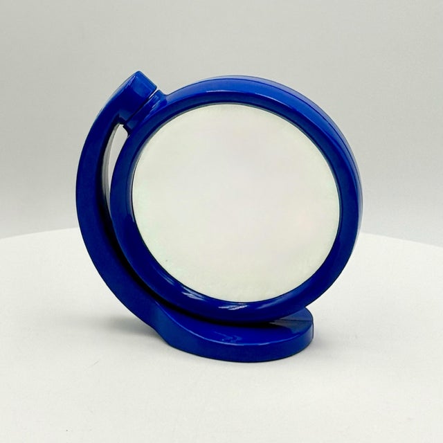 This blue Space Age vanity mirror from the 1970s combines functional design with a sculptural and expressive form. The...