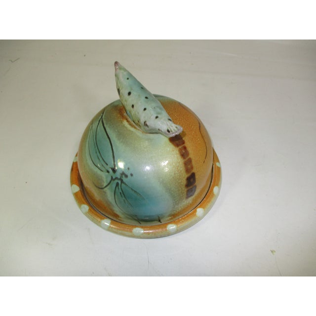 Hand crafted and hand painted pottery domed cheese server. This whimsical piece is painted in colors of copper and teal...