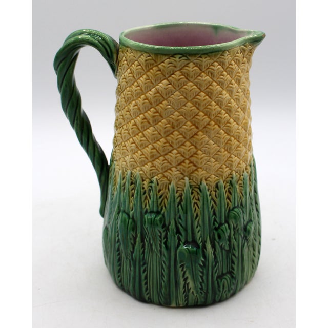 Circa 1880s pineapple pattern majolica pitcher, English. Twisted vine handle. The relief molded yellow pineapple...