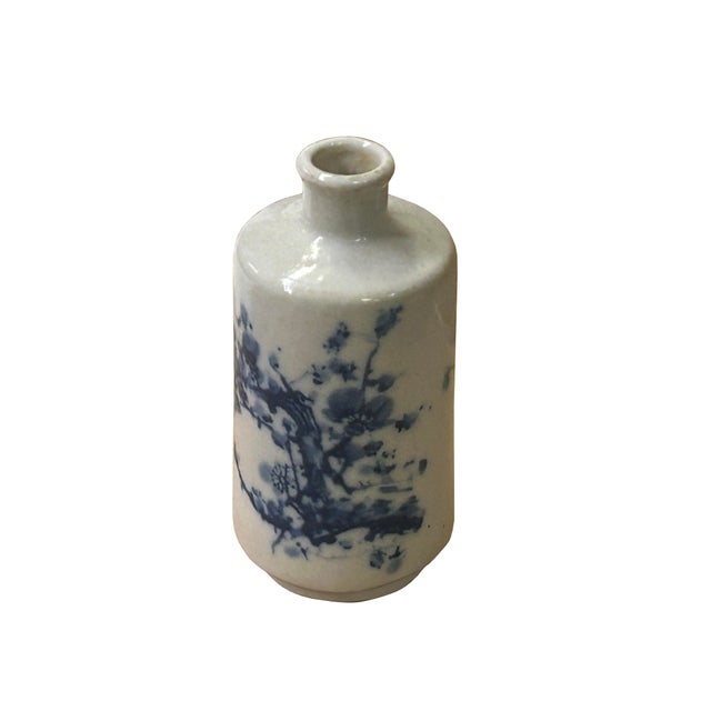 This small porcelain art vase features a cylindrical silhouette complemented by a short, narrow neck and a rounded rim....