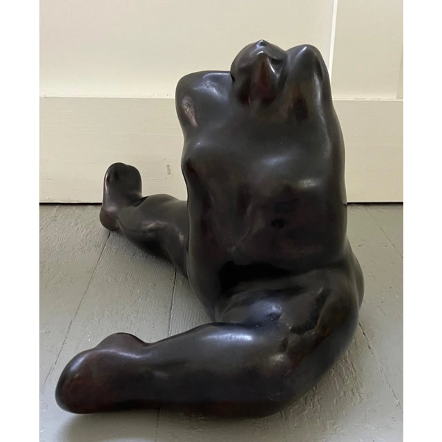 Sophia Vari (Greek b. 1940) bronze sculpture of a seated woman dancer stretching. Posed with her leg outstretched and her...
