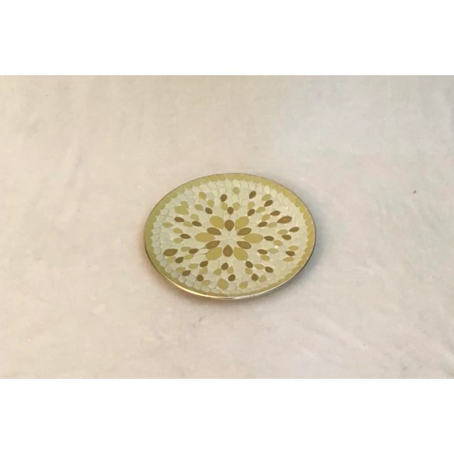 Vintage 12" in diameter dish with leaf-printed and almond shaped ceramic tiles. In tones of yellow set in plaster on a...