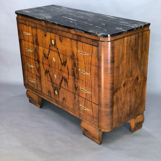 A 1940s Art Deco chest of drawers. Walnut burl frame, 20mm black Portoro marble top (an extremely rare marble found only...
