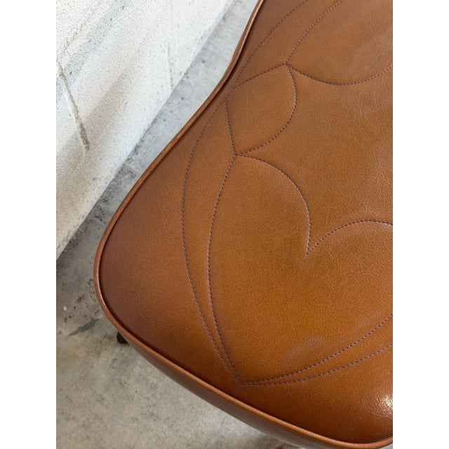 Vintage Scandinavian Mid Century leather footstool ottoman featuring a beautifully sculptural silhouette, warm cognac-...