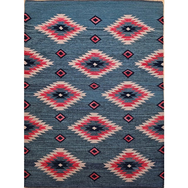 Add a touch of timeless Southwestern charm to your space with this vintage handwoven kilim rug, inspired by the geometric...