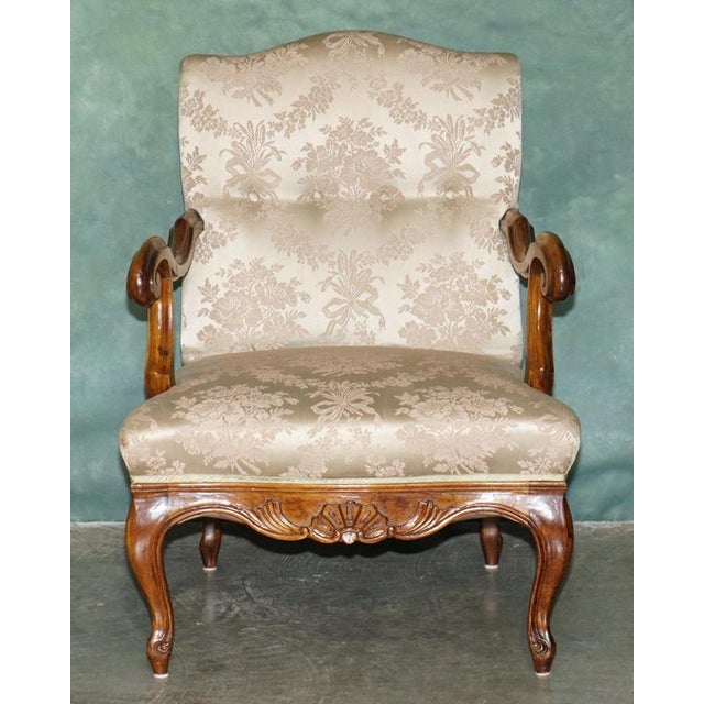 Elegant antique French walnut armchair, dating to Circa 1880 to 1900 Displaying the graceful curves associated with the...