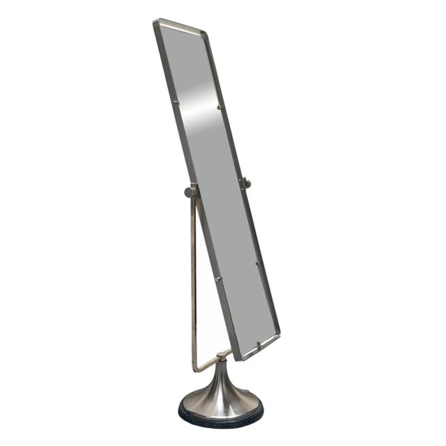 An exceptionally elegant rectangular tilting and swivelling mirror crafted from nickel-plated brass with brass detailing,...