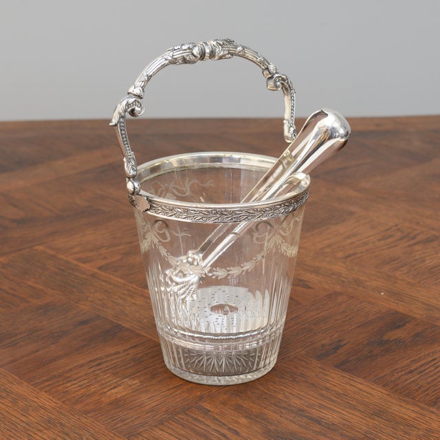 Silver plated crystal ice bucket with handle, strainer and claw tongs. Circa 1900.