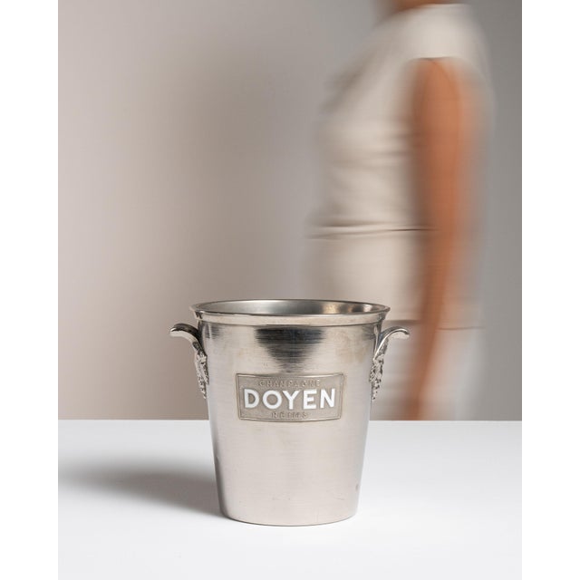 This mid 20th century ice bucket from France is finished in silver. It is engraved with the Doyen wordmark, a detail that...
