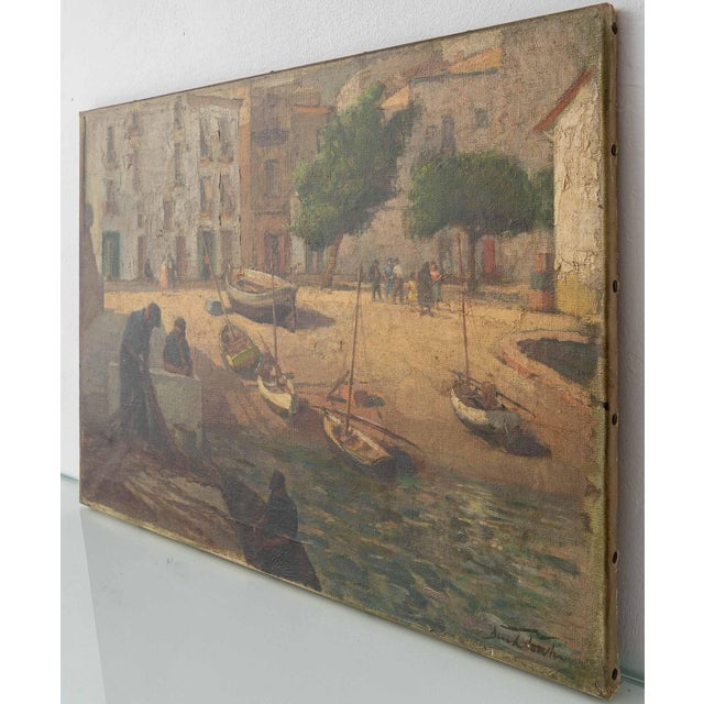 This early twentieth-century oil on canvas shows a Mediterranean fishing village at work. Men haul a net across a stone...