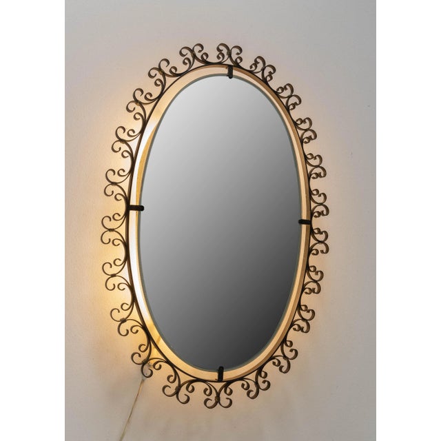 Metal lighted mirror with metal framework French mid-century Good vintage condition.