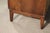 Mid-century modern dresser with nine drawers, curved front, and burl veneer.