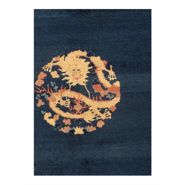Beautiful antique Peking Chinese hand-knotted wool rug with a blue field. This Chinese rug has a beige frame and Light...