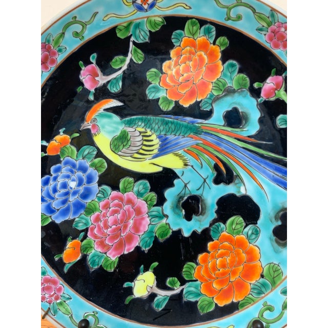 Beautiful vintage hand-painted decorative porcelain plate featuring a colorful exotic bird surrounded by vibrant floral...
