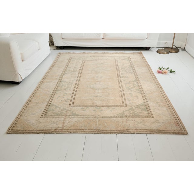 Create a serene and sophisticated atmosphere in your home with this beautiful vintage Turkish rug. This hand-knotted piece...