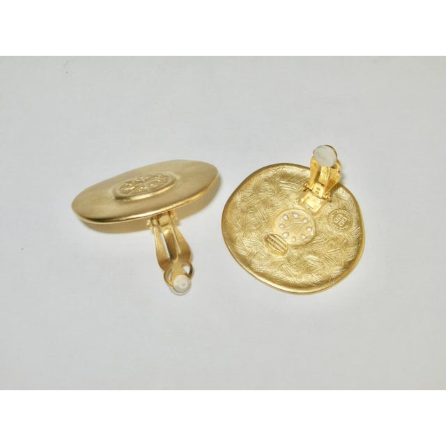 This is part of Chairish’s Costume Jewelry assortment. Gorgeous 1980s Givenchy open work matte gold tone clip back...
