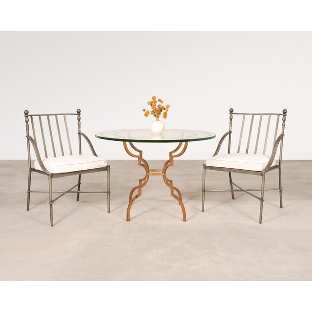 A distinctive signed set of four Michael Taylor "Montecito" dining chairs featuring an intentionally distressed powder...