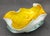 Offered is a mid 20th Century hand-blown cased art glass bowl featuring a vibrant yellow interior with aventurine or gold...