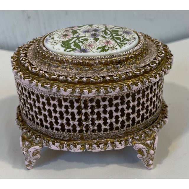 Beautiful pink and gold metal trinket box with a porcelain floral design top. Marked Firenze