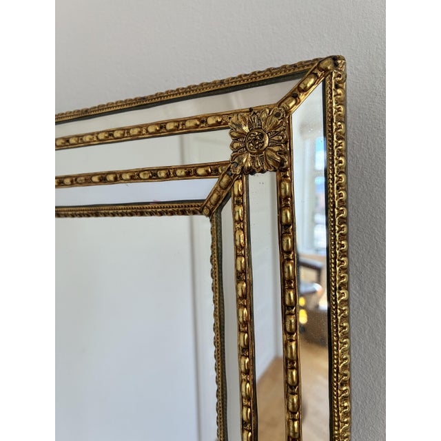 A large vintage Spanish Venetian-style rectangular beveled wall mirror, dating to the 1980s. The mirror has a decorative...