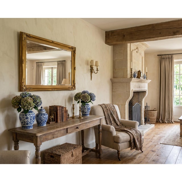 A highly decorative early 20th-century French giltwood wall mirror, designed with an elegant facet-cut / bevelled mirror...