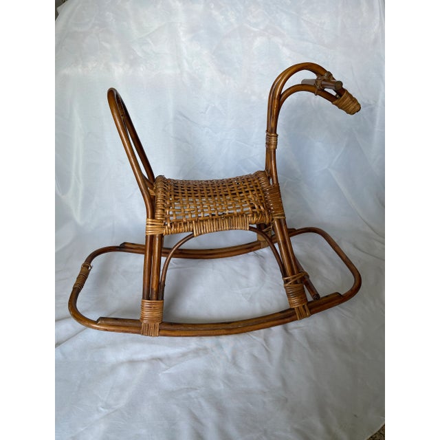 Large rattan rocking horse with a caned seat. A whimsical addition to any nursery!