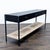 Three drawer table with brass hardware and woven rope shelf. Brand: Arhaus. Dimensions (in): 72W x 18D x 29H.