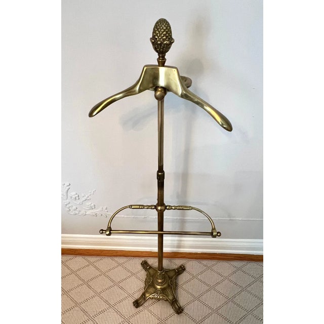 Solid brass valet adjustable from 48" - 60". Holds pants, coat and a place for change, wallet, watch, etc. - a compliment...