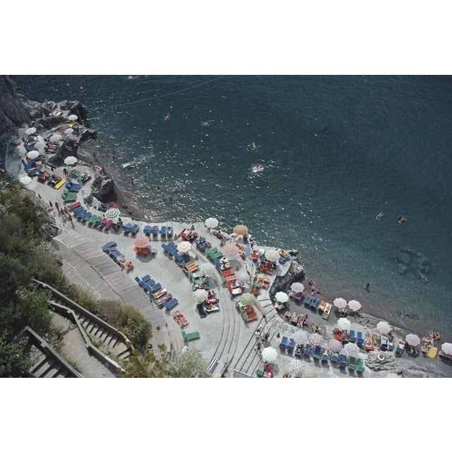 Positano Beach 1979 Elevated view looking down on sunbathers and parasols on the beach at La Scogliera beach in Positano,...
