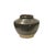 The image shows a small, stout ceramic jar with a rounded body that tapers towards a narrow, slightly everted rim. The...
