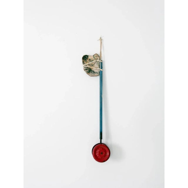 A classic vintage N.N. Hill Brass Company pull toy, circa 1940s. features a painted wooden horse head mounted on a blue...