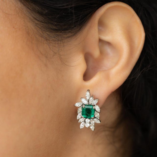 Platinum earrings set with two GIA certified fine Colombian emeralds weighing 2.66 carats and 30 marquis cut and 4 round...