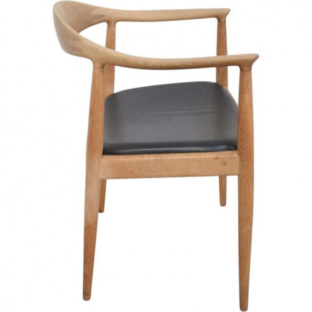 Hans Wegner The Chair, model JH503, with a frame of oak and a seat upholstered in black leather. The chair is from the...