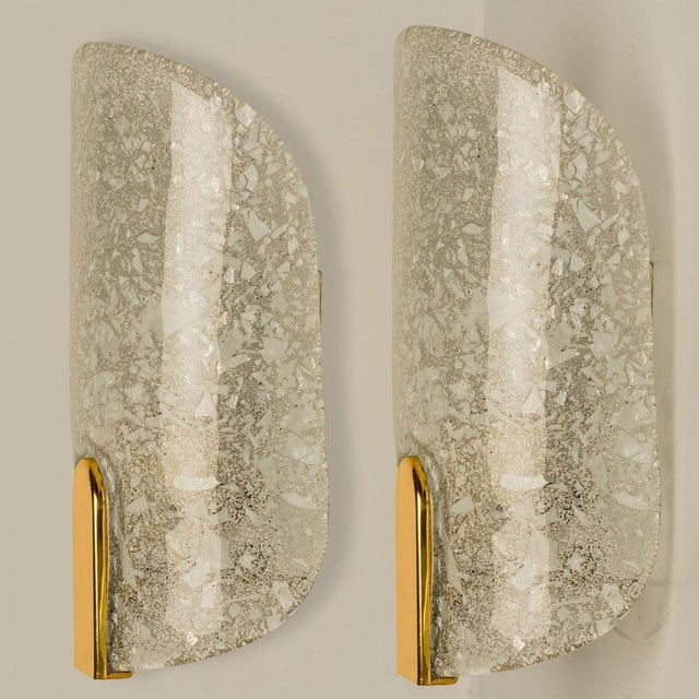 Pair of thick textured ice glass wall lights, designed in germany around the 1960s. These messing wall lights are...