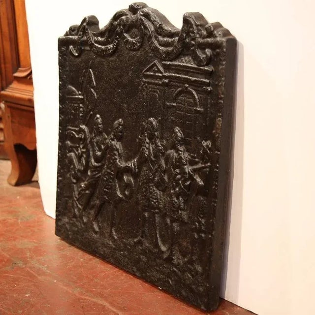 Decorate a fireplace or kitchen hearth with this elegant antique French iron fireback, crafted circa 1760. The rectangular...