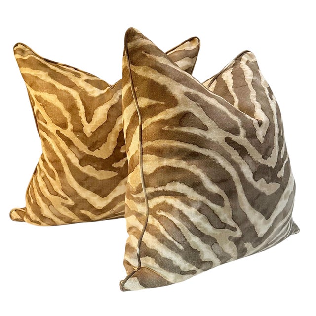 A pair of vintage down filled pillows upholstered in a linen and cotton blend featuring the iconic Clarence House Tiger...