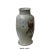 This is a handmade ceramic small jar vase with a rough uneven surface and shape. It has a vintage off white gray tone...