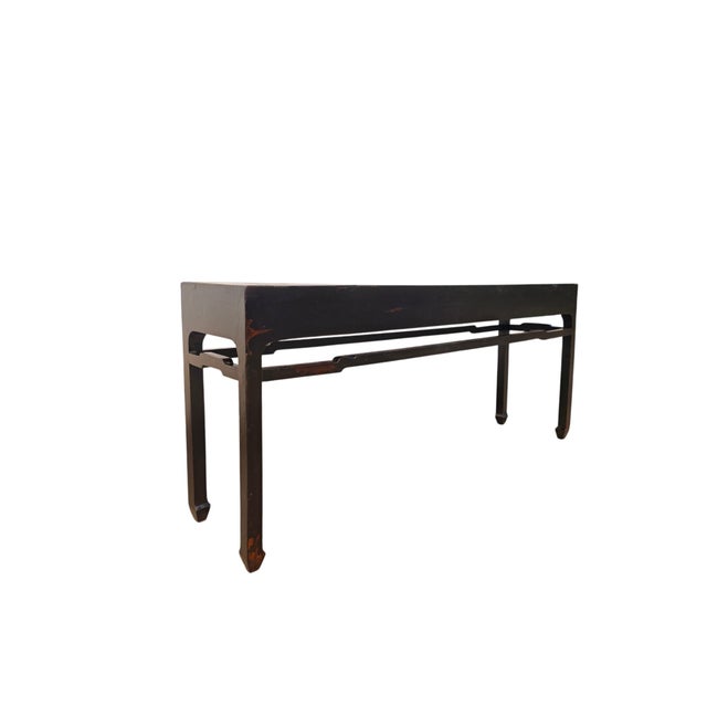 This 19th century console table features a long, narrow silhouette with a minimalist, architectural profile. Covered in a...