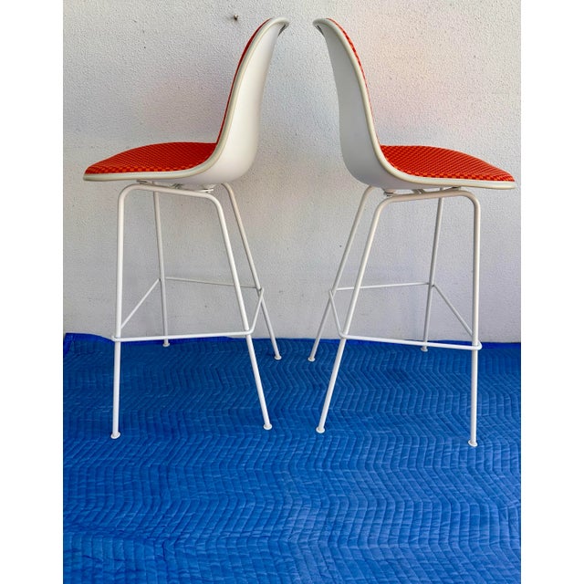Gorgeous pair of Eames Herman Miller Alexander Girard upholstered bar stools. The stools feature the iconic Eames design...