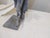 This distressed sculpture made of pot metal and finished with zinc, is mounted on a slab of grey marble.