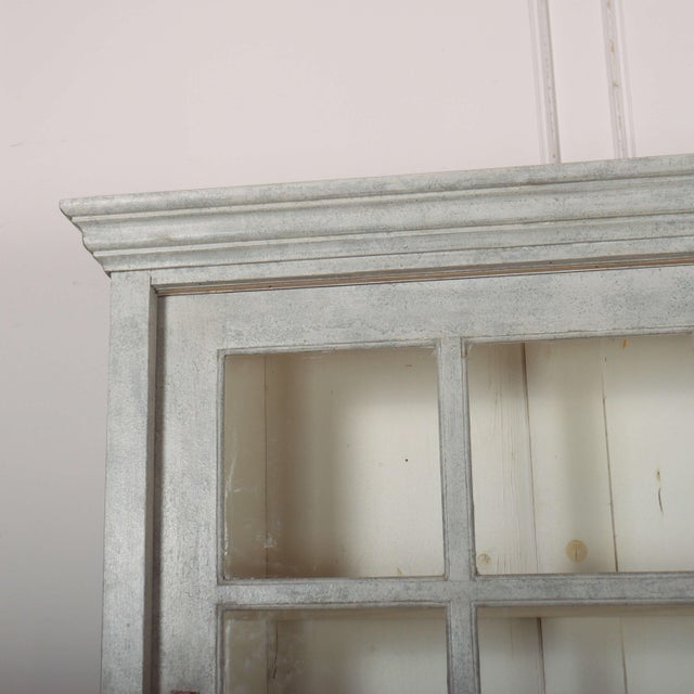 Useul 19th century painted and glazed pine kitchen dresser with sliding doors. 1880. This piece is designed in the style...