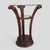 An early 20th-century Art Nouveau side table with a circular glass top, carved wood pedestal base, and a smaller round...