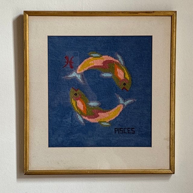 Offering a gorgous mid-20th century Pisces Zodiak needlepoint presented in its original gilded wood frame under glass....