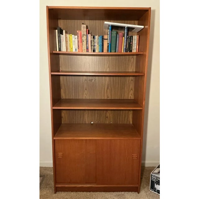 This striking Danish Modern bookcase wall unit exemplifies the clean lines and functional elegance of mid-century...